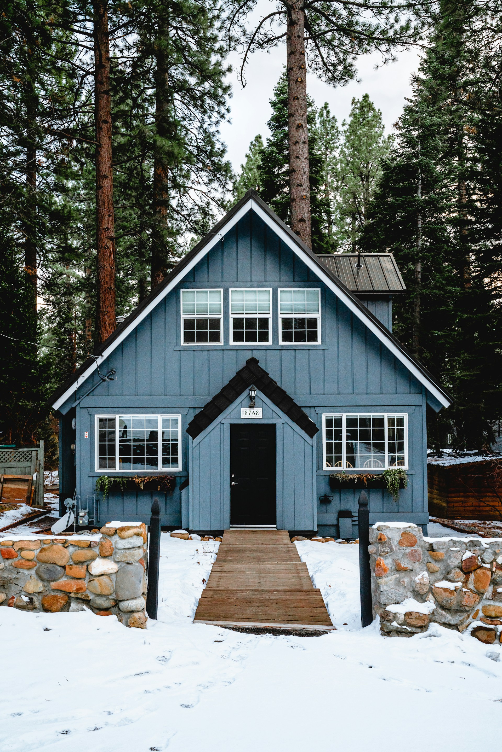 A photo of a wooden house in the forest